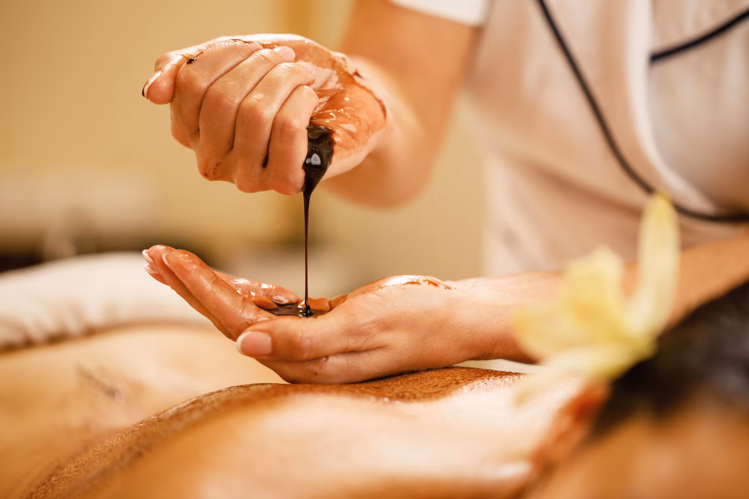 Professional spa therapist preparing for massage treatment